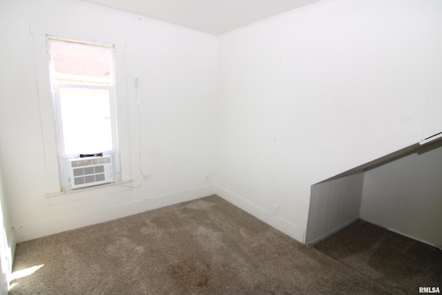 unfurnished room featuring dark colored carpet and cooling unit