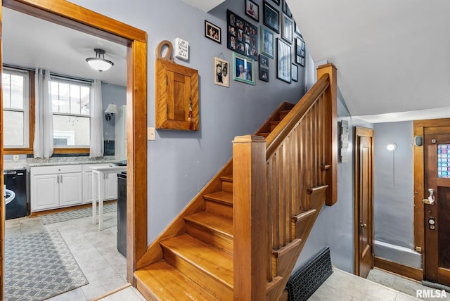 stairway with tile patterned flooring