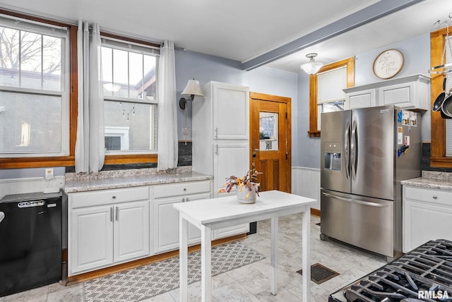 kitchen featuring white cabinetry, stainless steel fridge, and black dishwasher