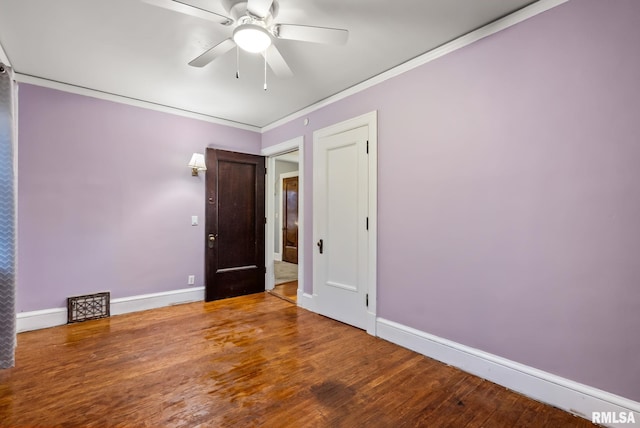 empty room with hardwood / wood-style floors, ceiling fan, and ornamental molding