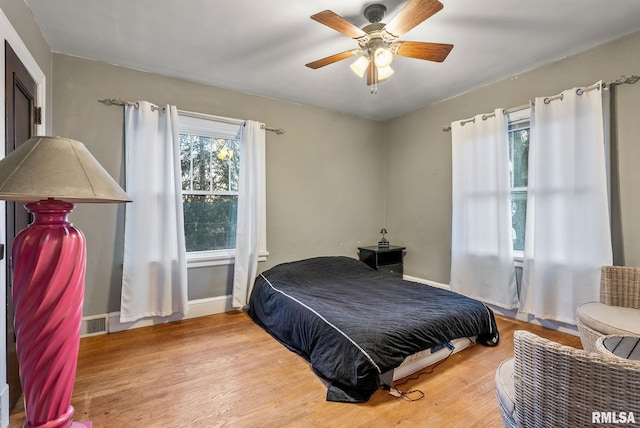 bedroom with hardwood / wood-style floors and ceiling fan