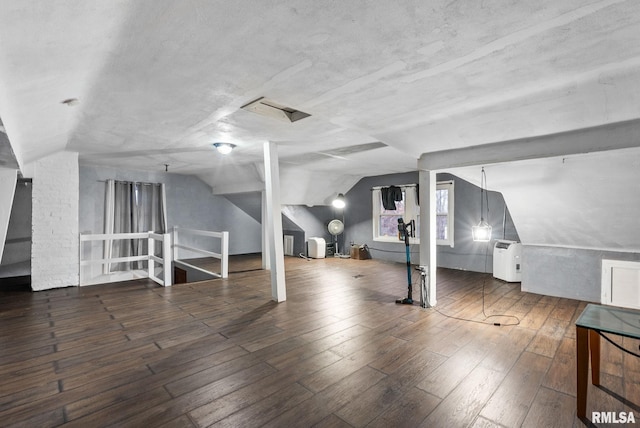 bonus room featuring dark wood-type flooring and lofted ceiling