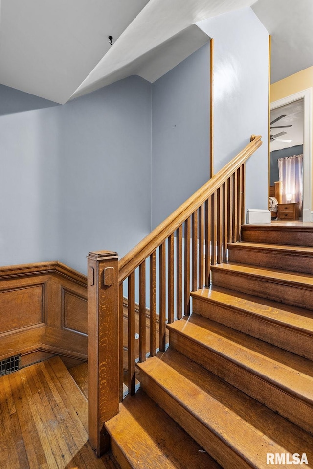 stairs featuring hardwood / wood-style flooring