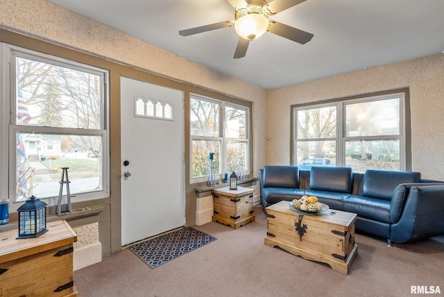 carpeted living room featuring ceiling fan