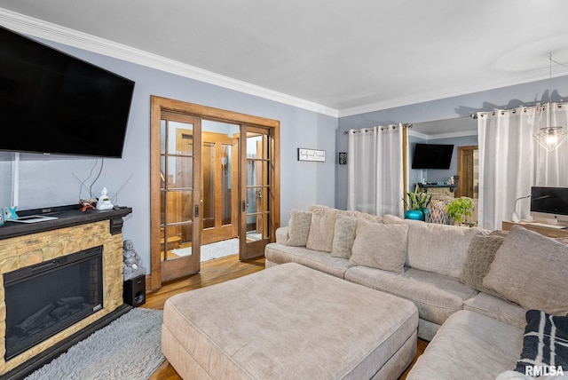 living room featuring a fireplace, light hardwood / wood-style flooring, and ornamental molding