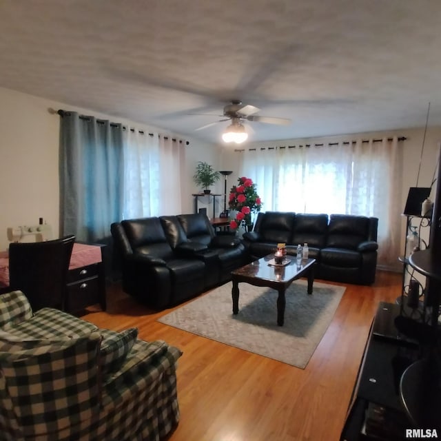 living room featuring hardwood / wood-style flooring and ceiling fan