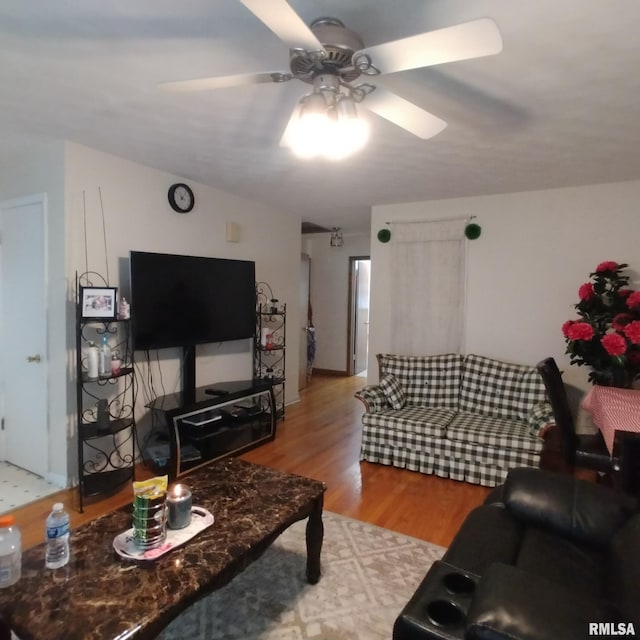 living room featuring ceiling fan and light hardwood / wood-style floors