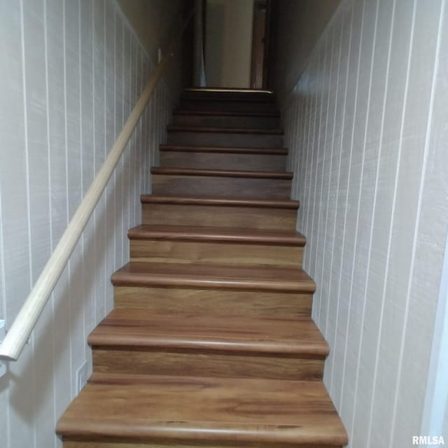 staircase with wooden walls