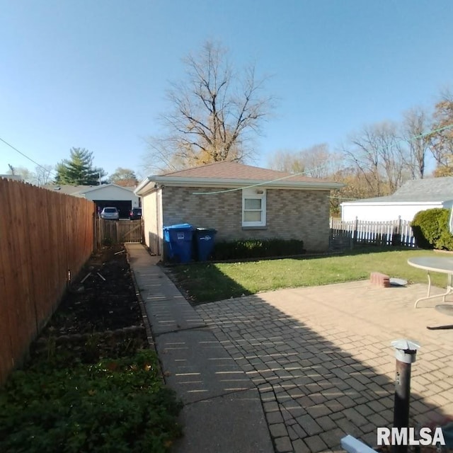 view of property exterior featuring a yard and a patio area