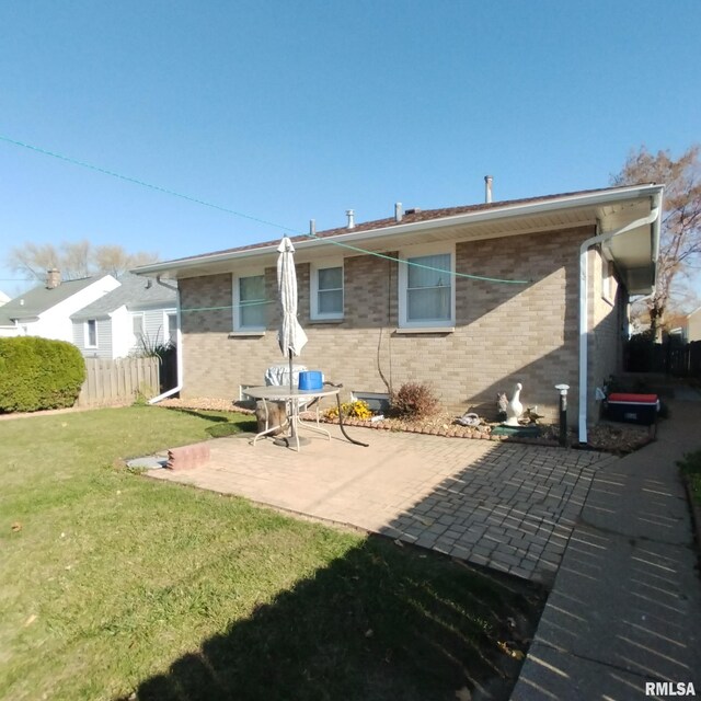 view of side of property with a yard and a patio