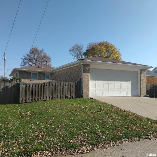 view of front of property with a garage and a front yard