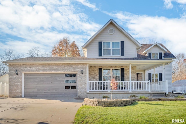 view of front of property featuring a front yard, a porch, and a garage