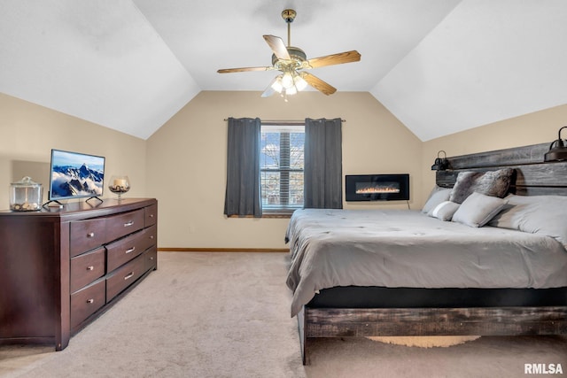 bedroom with ceiling fan, lofted ceiling, and light carpet