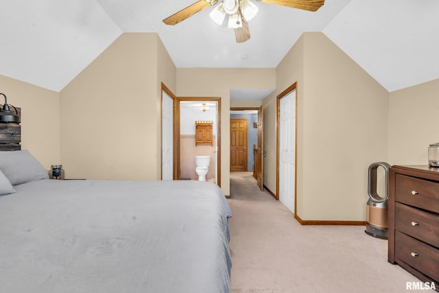 bedroom with light carpet, ensuite bathroom, vaulted ceiling, and ceiling fan