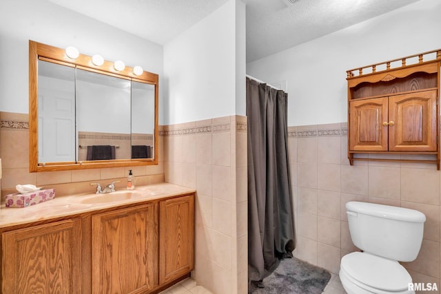 bathroom featuring a textured ceiling, toilet, and tile walls