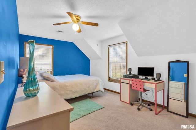 carpeted bedroom featuring lofted ceiling, ceiling fan, and a textured ceiling