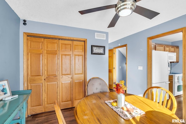 dining room with ceiling fan and dark hardwood / wood-style flooring