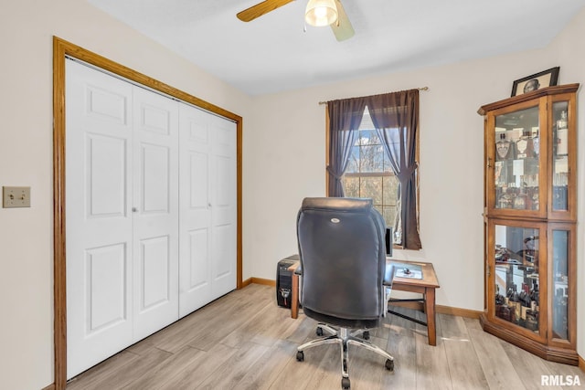 office featuring light hardwood / wood-style floors and ceiling fan