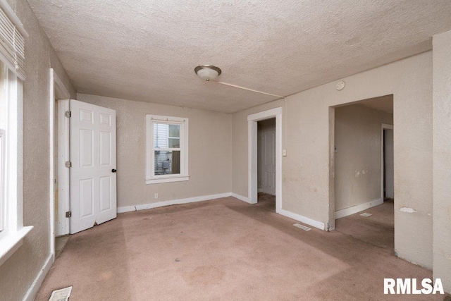 unfurnished room with a textured ceiling