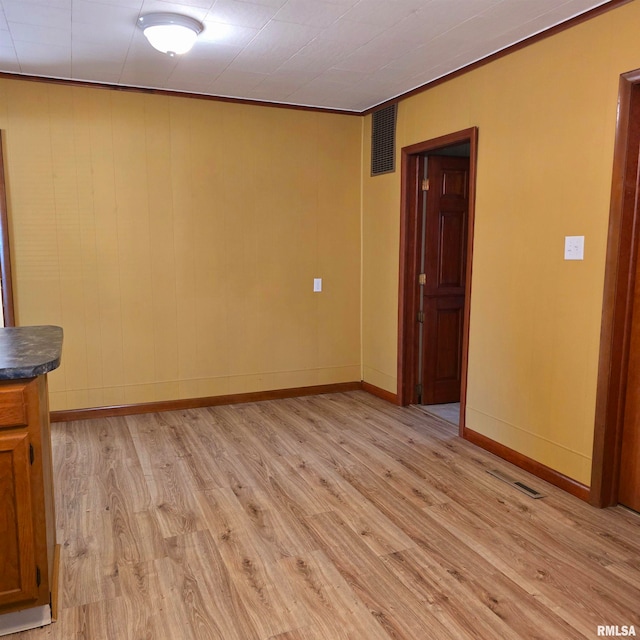 empty room with light hardwood / wood-style floors