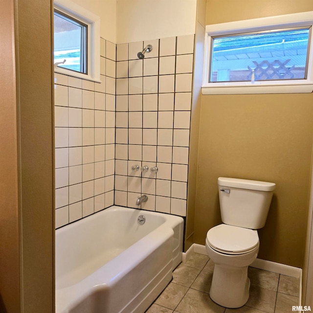 bathroom with tiled shower / bath, tile patterned floors, and toilet