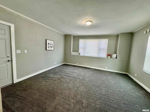 carpeted spare room with a textured ceiling and ornamental molding