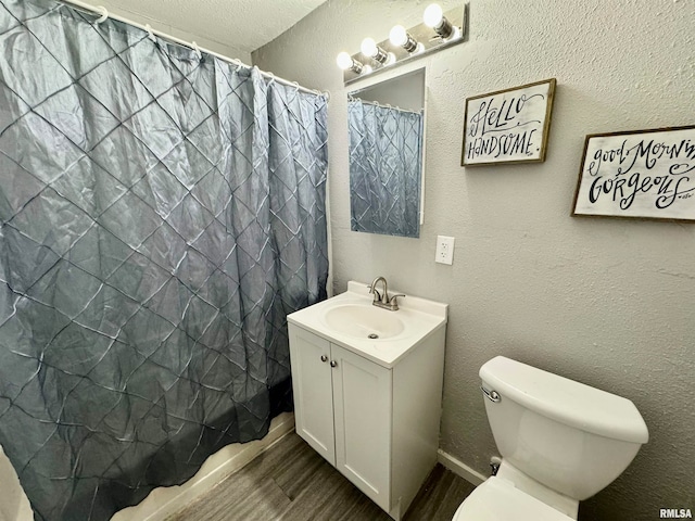 bathroom with hardwood / wood-style flooring, vanity, and toilet