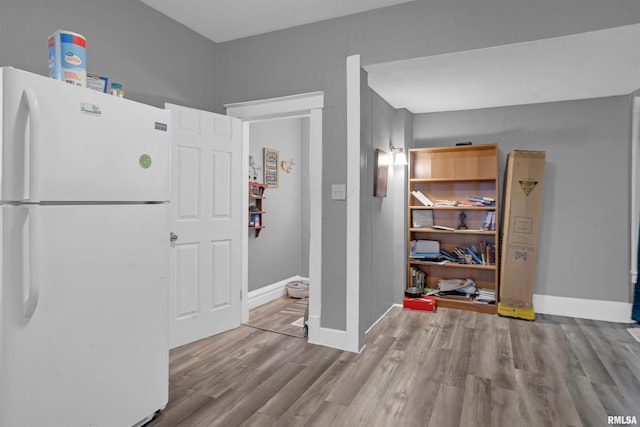 interior space with white fridge and light hardwood / wood-style flooring