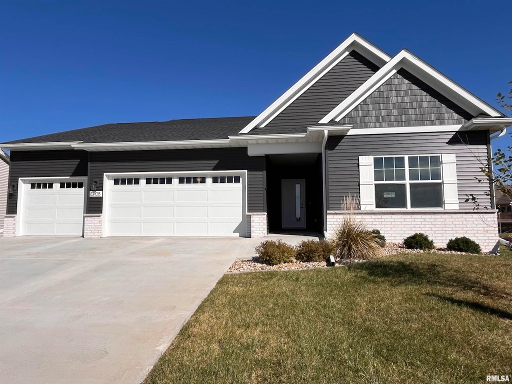 craftsman-style house featuring a garage and a front lawn