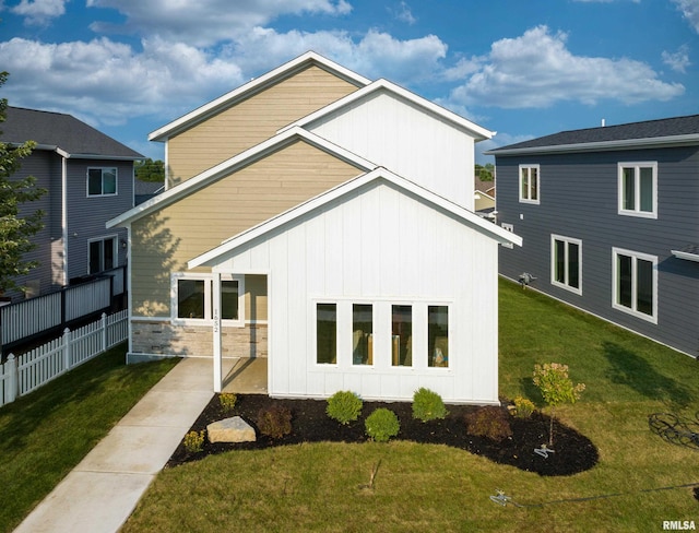 rear view of property with a yard