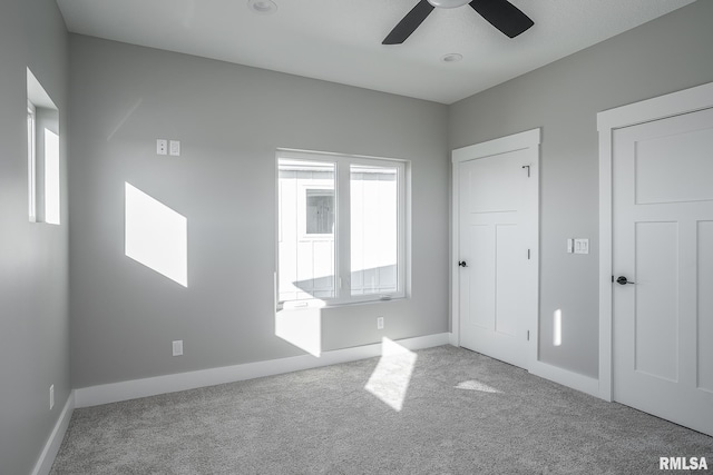 unfurnished bedroom featuring light carpet and ceiling fan