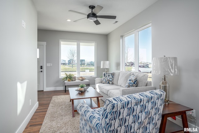 living room featuring dark hardwood / wood-style floors and ceiling fan