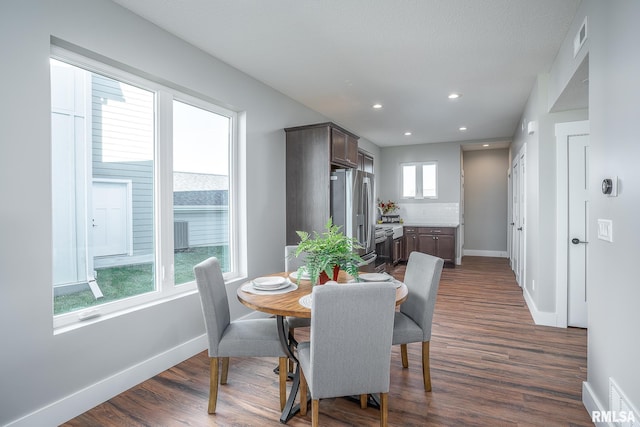 dining room featuring a textured ceiling and dark wood-type flooring