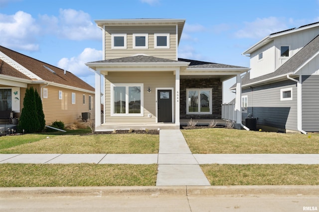 view of front of property with cooling unit and a front yard