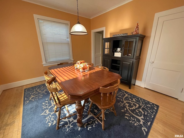 dining room with light hardwood / wood-style floors and ornamental molding