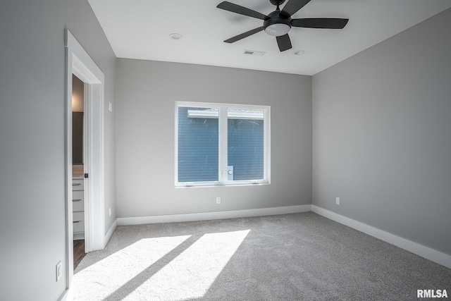 carpeted spare room with ceiling fan