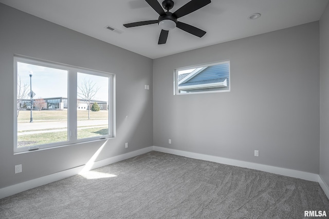 carpeted spare room with ceiling fan