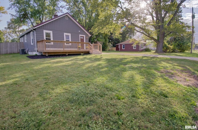 view of yard featuring central AC, an outbuilding, and a deck