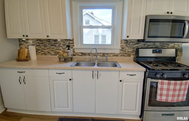 kitchen with white cabinets, sink, and appliances with stainless steel finishes