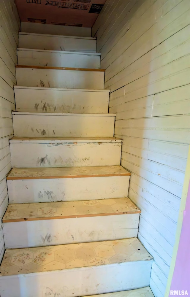 stairway with wood walls