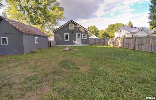 rear view of property with a lawn