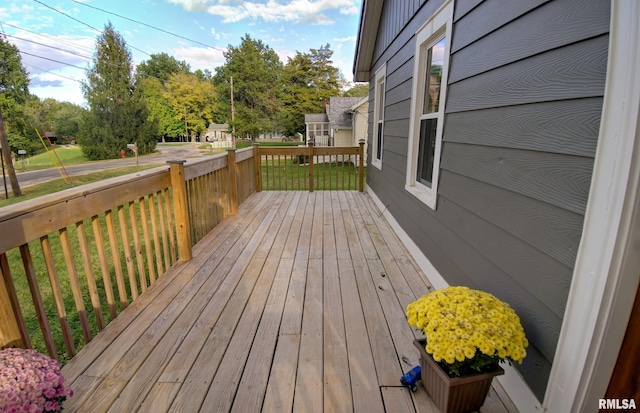 wooden terrace with a lawn