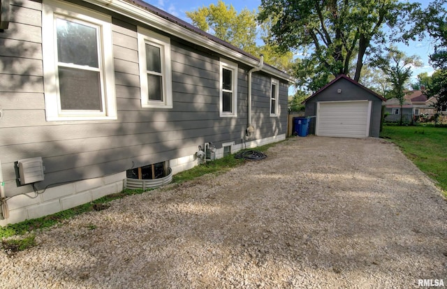 view of home's exterior featuring an outdoor structure and a garage