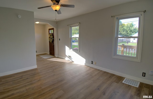 unfurnished room with light wood-type flooring and ceiling fan