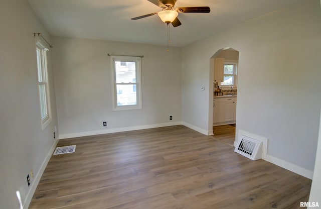 unfurnished room with light hardwood / wood-style floors, plenty of natural light, and ceiling fan