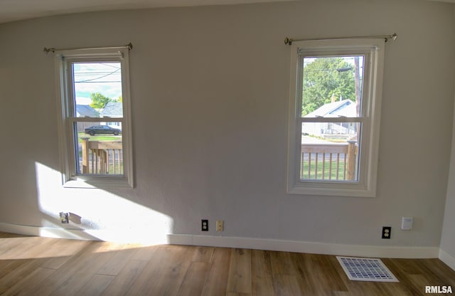 empty room with hardwood / wood-style floors