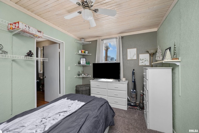 bedroom featuring dark colored carpet, ceiling fan, and wooden ceiling