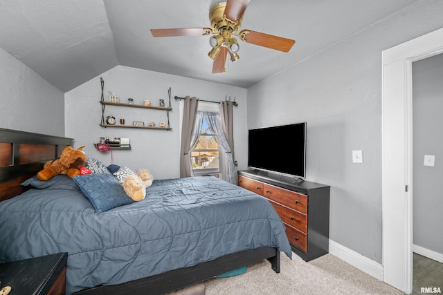 bedroom with ceiling fan, lofted ceiling, and carpet floors