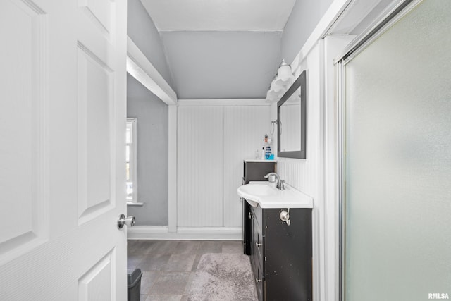 bathroom featuring vanity and a shower with door