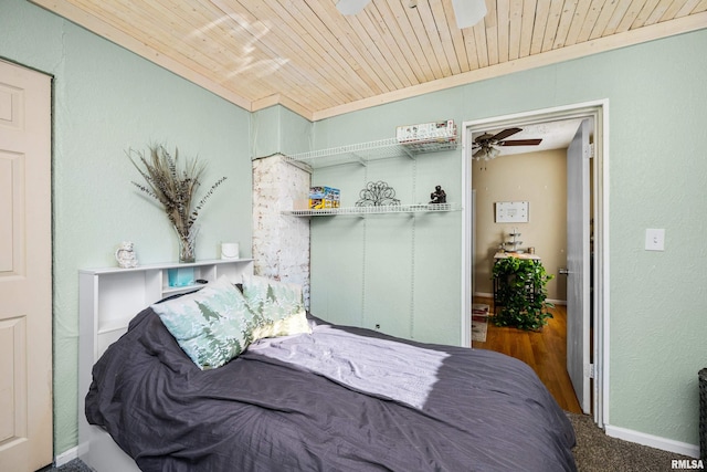 bedroom featuring dark carpet and wood ceiling